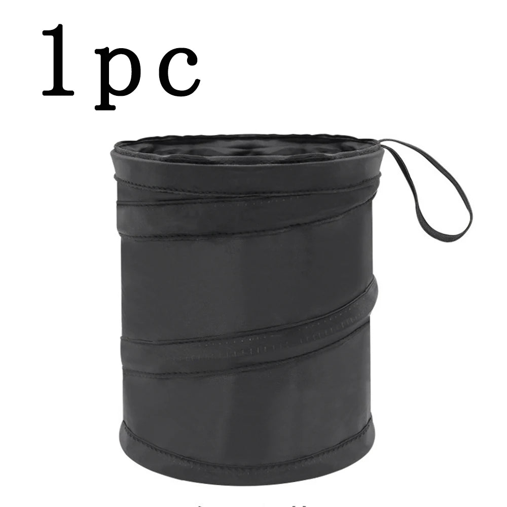 Black folding stool with a strap on a white background