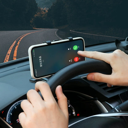 Person using a smartphone app on a car dashboard with a scenic road in the background