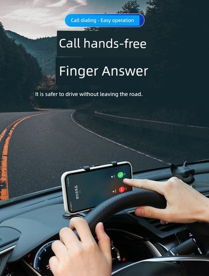 Person using a phone mount on a car dashboard with a scenic road in the background