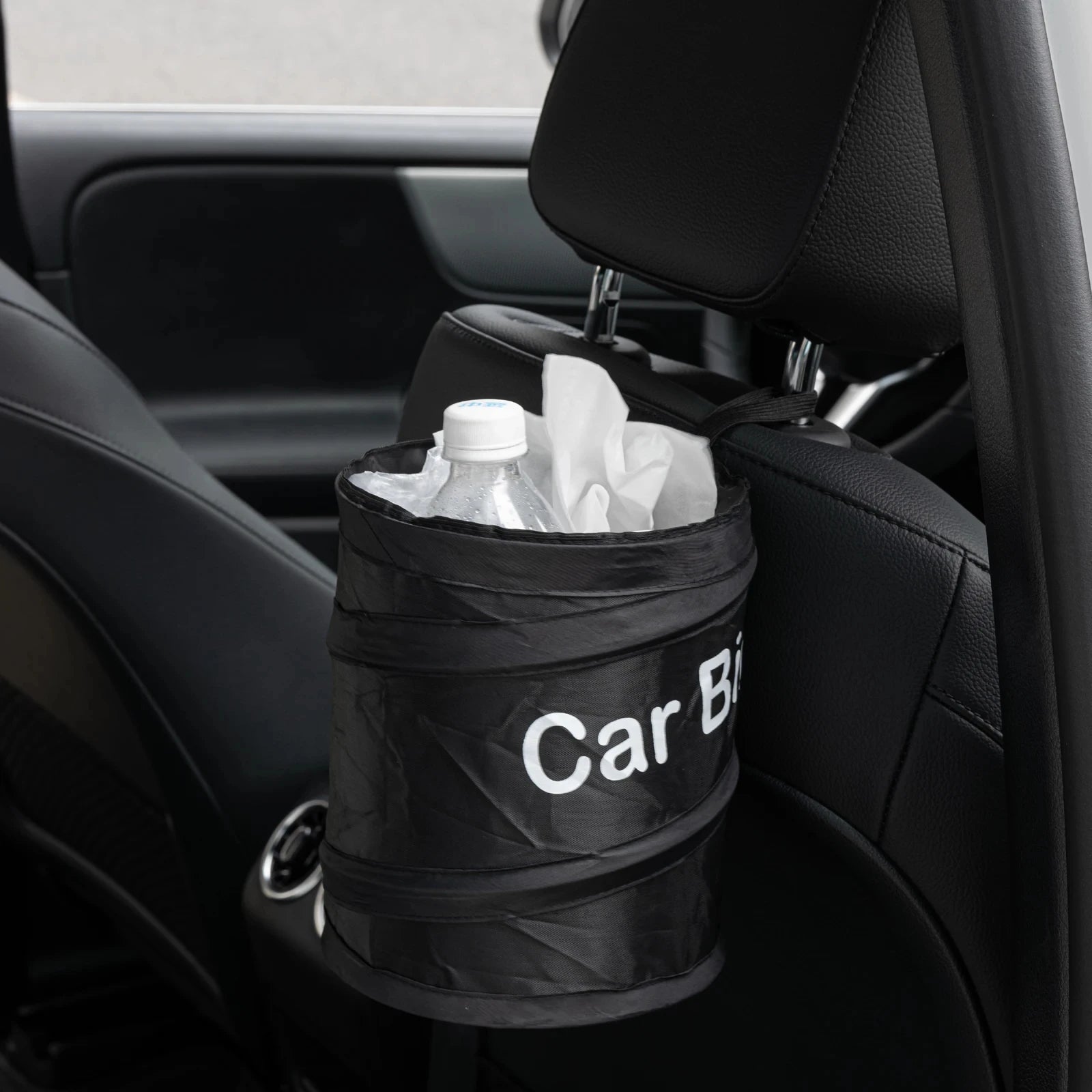 Black car bin with 'Car Bin' text attached to a car's headrest.