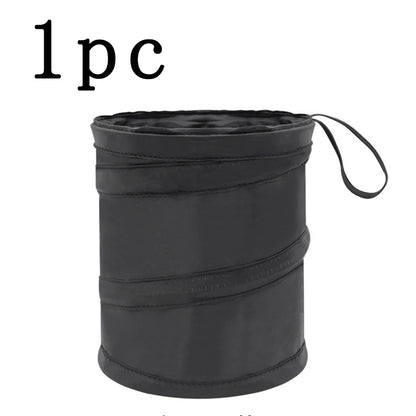 Black folding stool with a strap on a white background